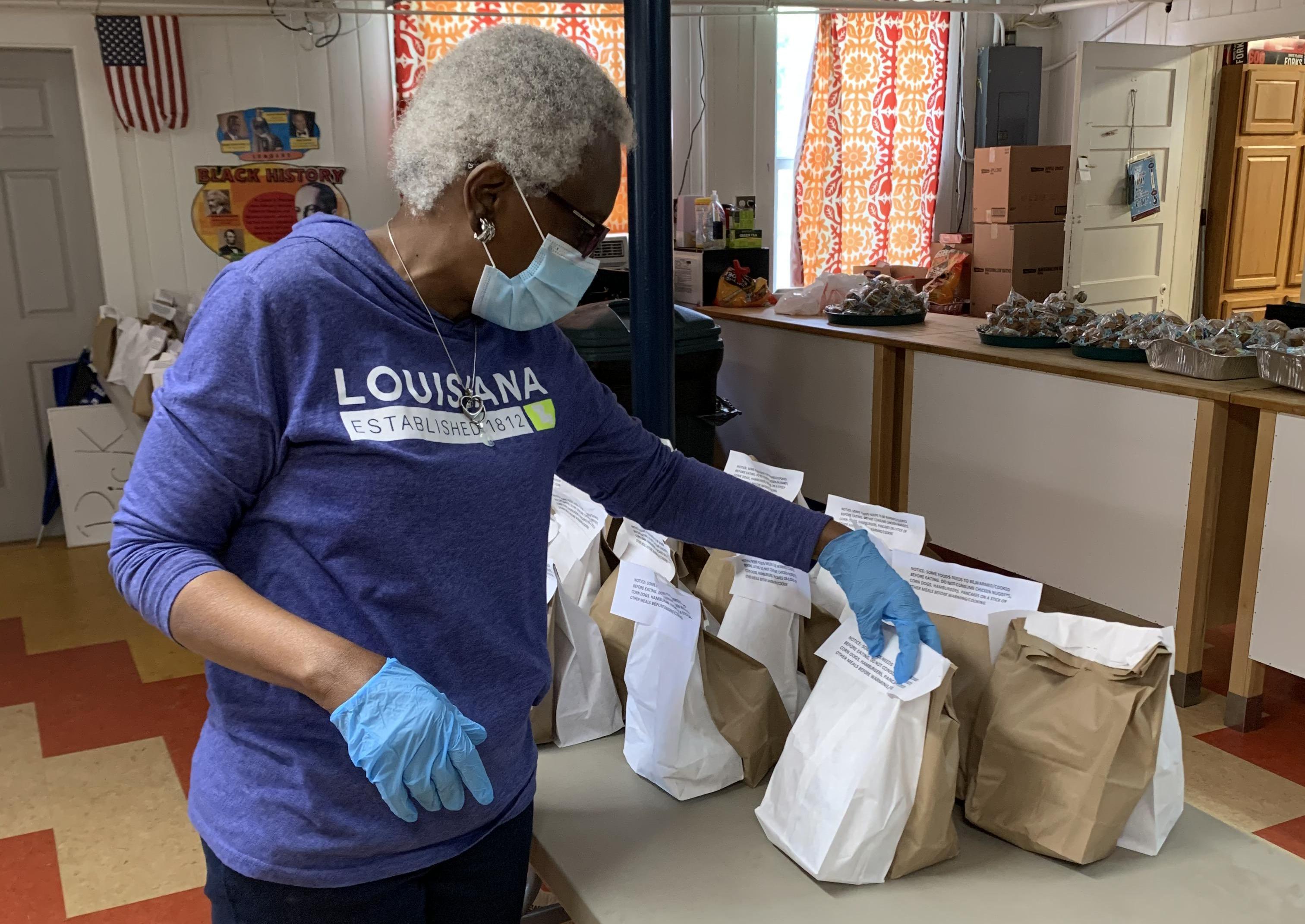 Director Julia Richard prepares sack lunches for children in the area during the COVID-19 pandemic at the Thensted Center in Grand Coteau, Louisiana
