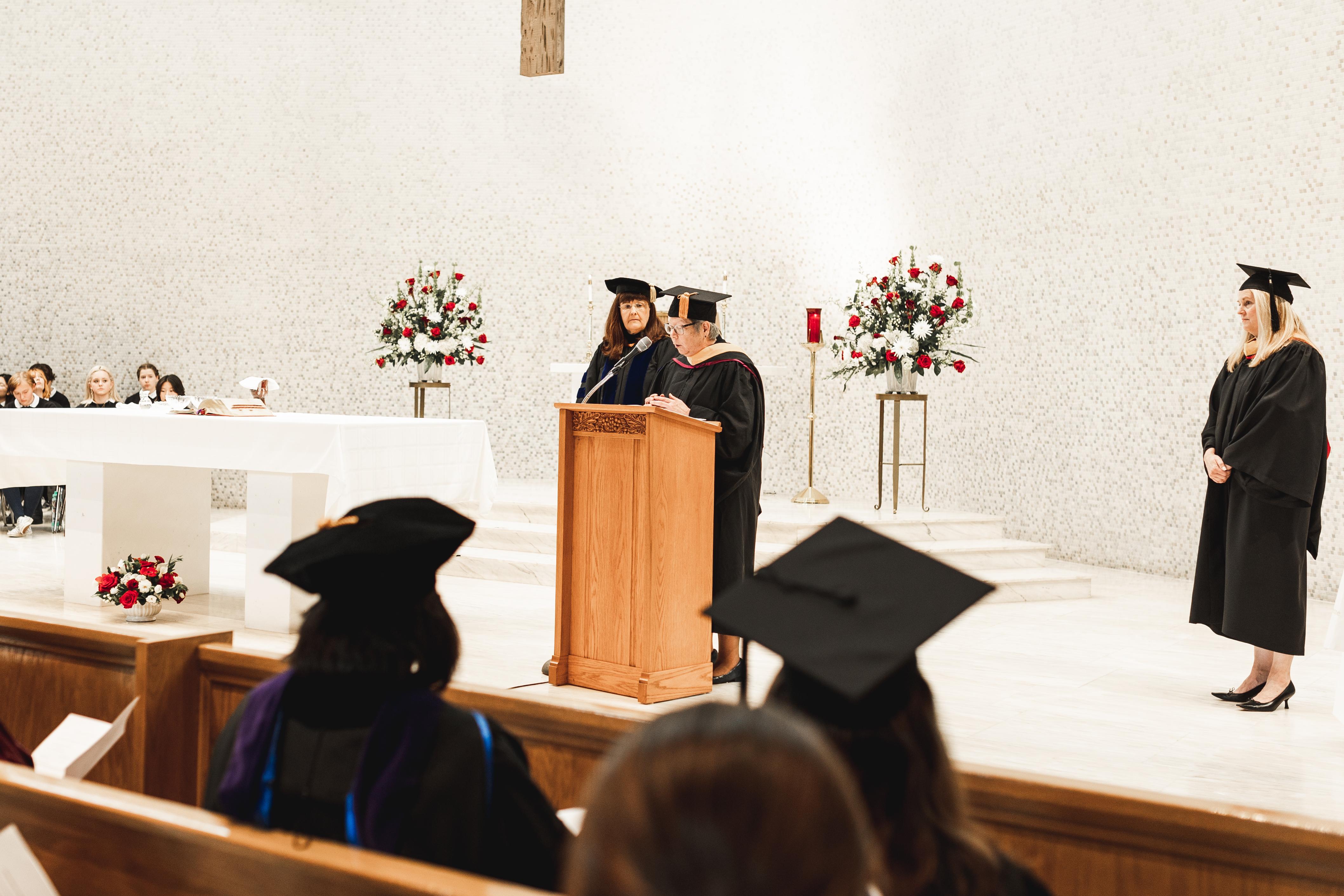 Suzanne Cooke, RSCJ, leads a blessing of Dr. Susan Tyree Dempf (left). (Photo courtesy of Woodlands Academy of the Sacred Heart)