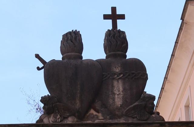 Original pierced Sacred Heart logo at the gates of the Villa Lante in Rome.